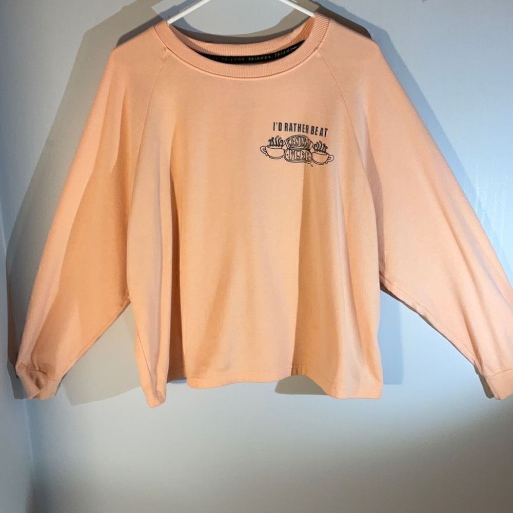 Friends Cropped Dolman Sleeve Central Perk Sweatshirt. Peach, Medium